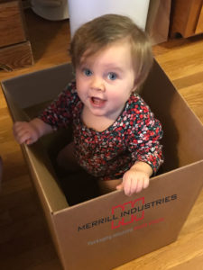 child playing in corrugated box